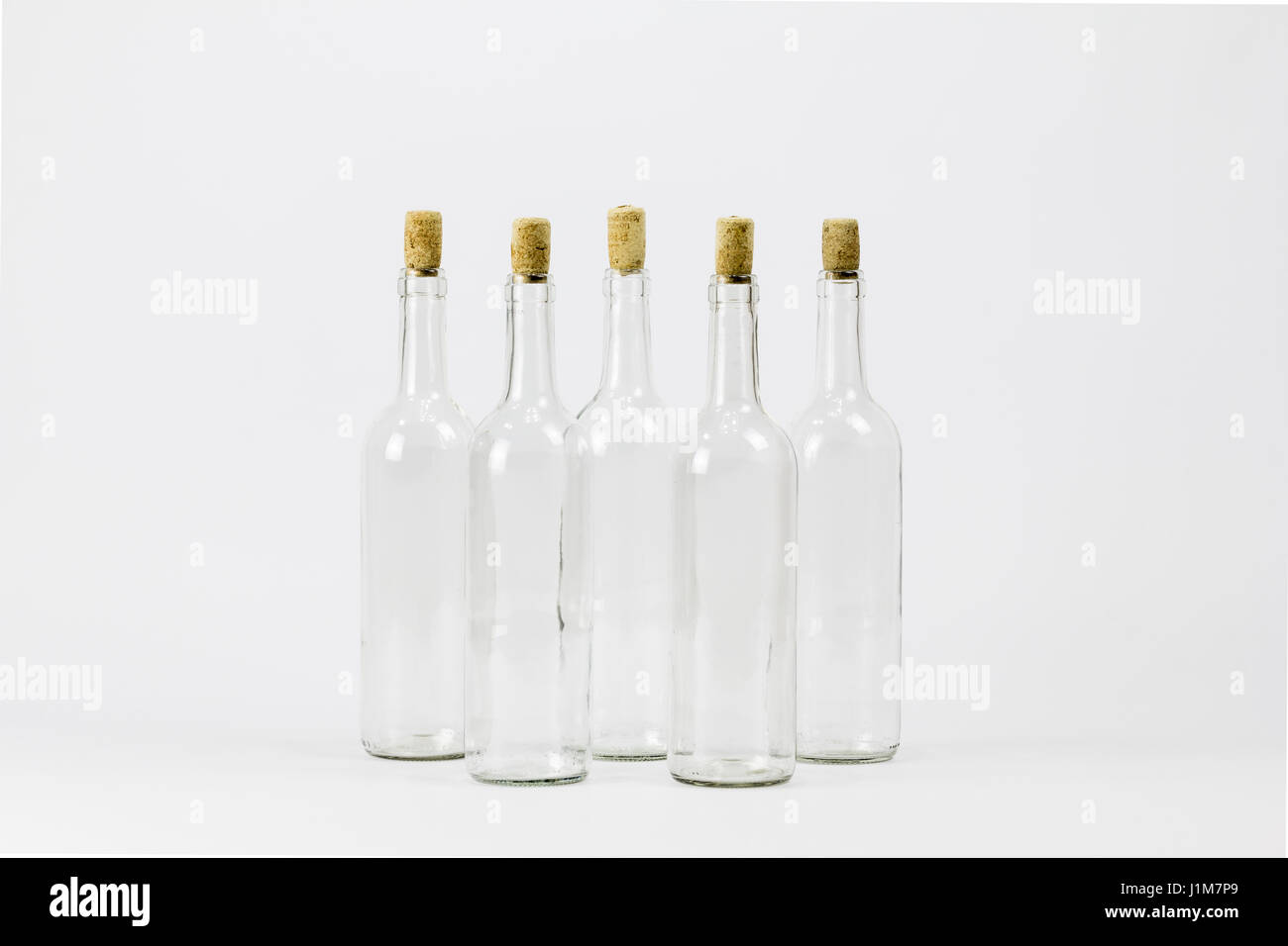 Group of empty glass bottle with cork isolated on white background
