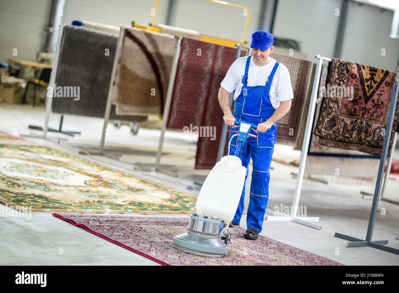 Worker cleaning vacuum cleaner  carpets Stock Photo