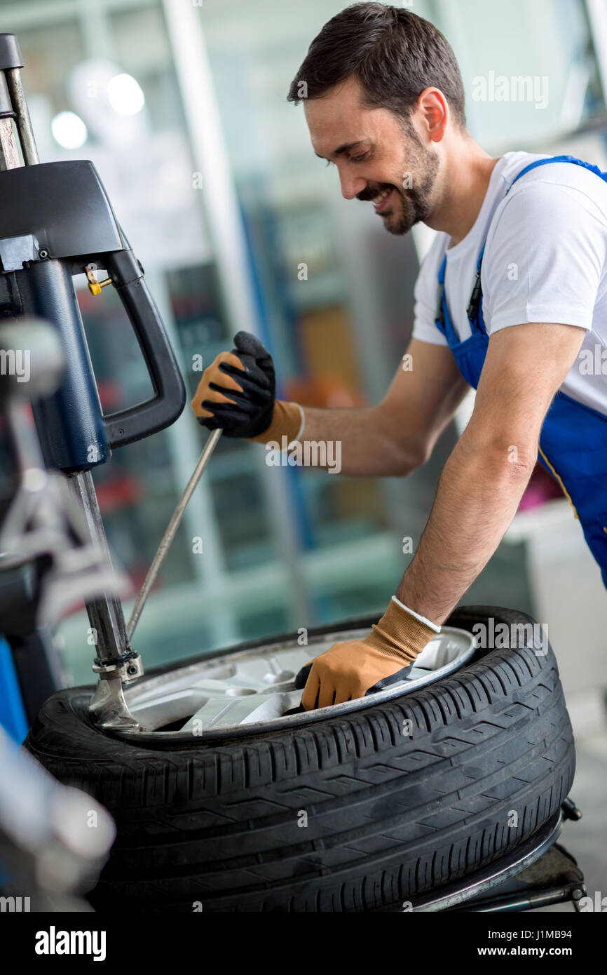Engineer replace tire on wheel in Stock Photo Alamy