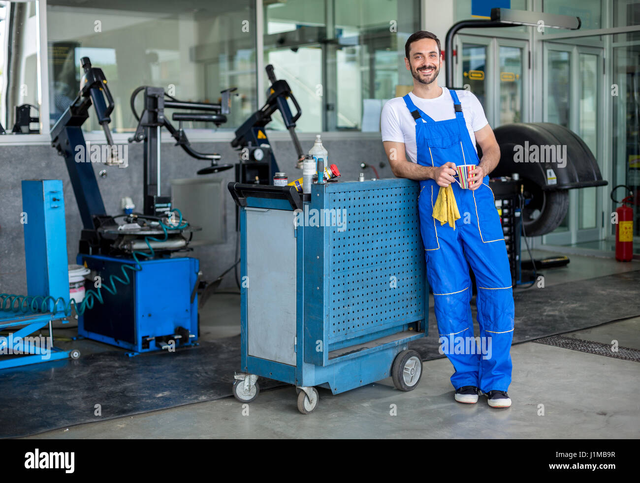 Smiling male engineer in an auto repair shop Stock Photo