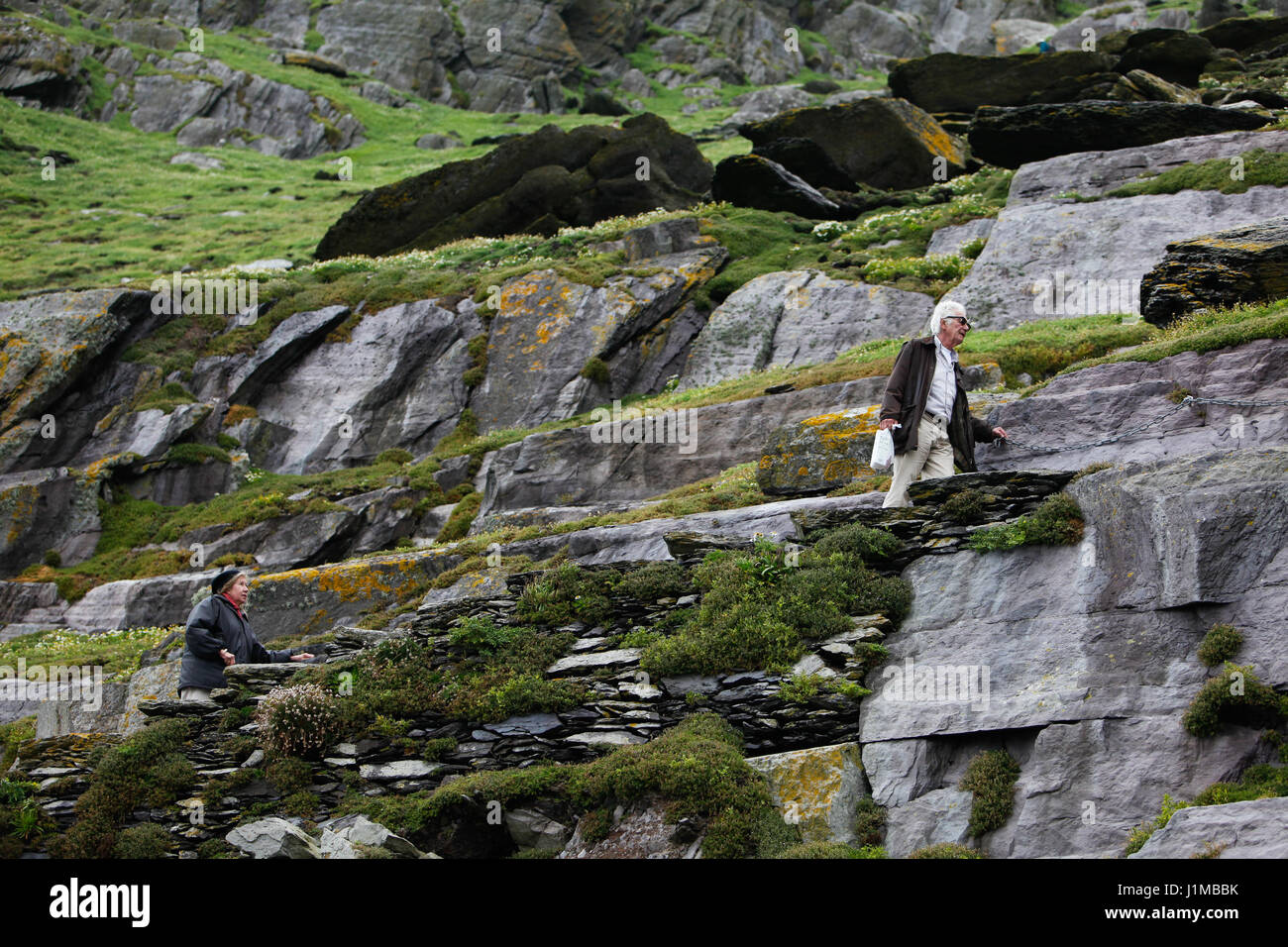 Walking the narrow stone path on Skellig Michael, County Kerry with a sheer drop on either side. Stock Photo