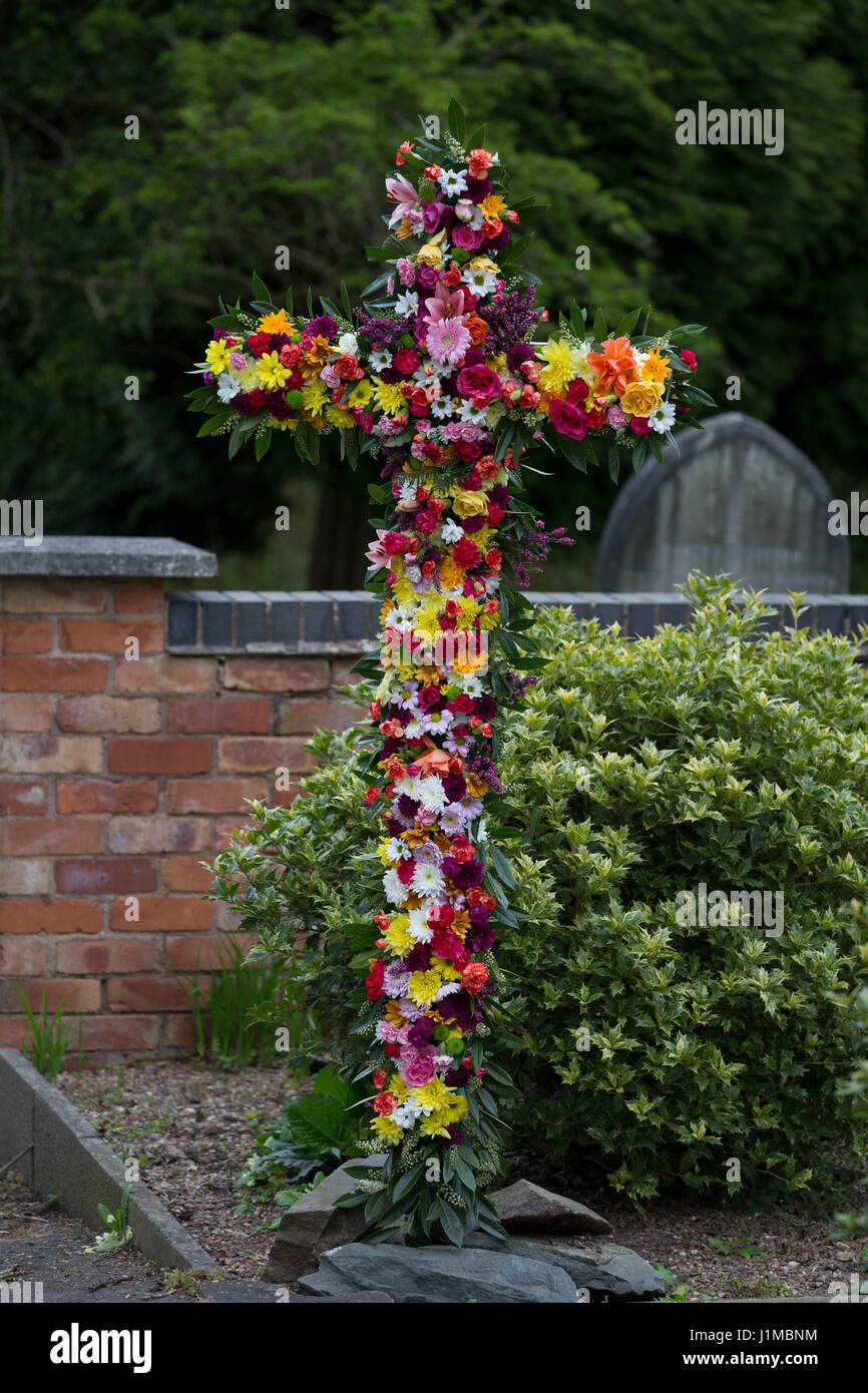 Easter Cross decorated with flowers by the congregation Stock Photo