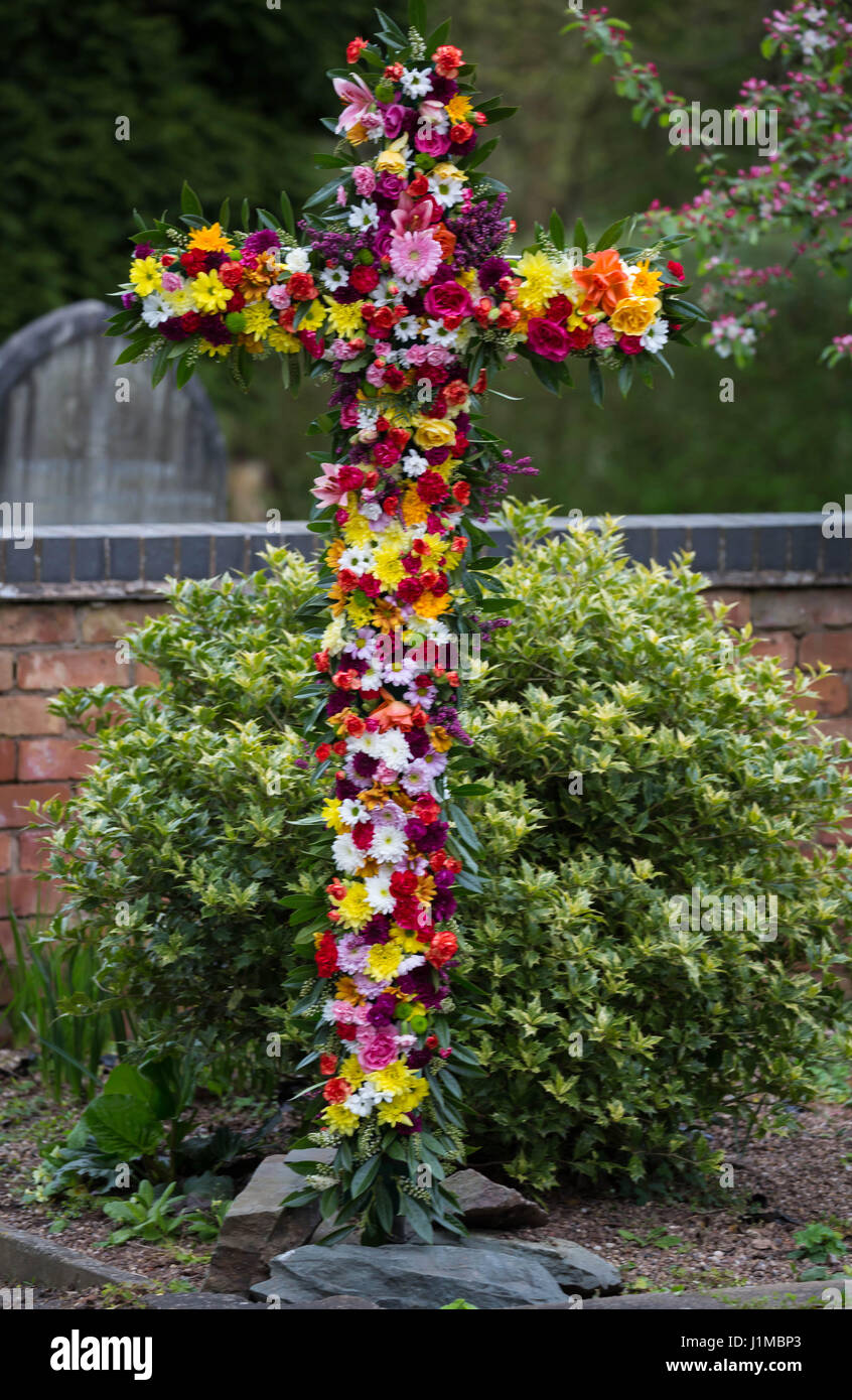 Easter Cross decorated with flowers by the congregation Stock Photo