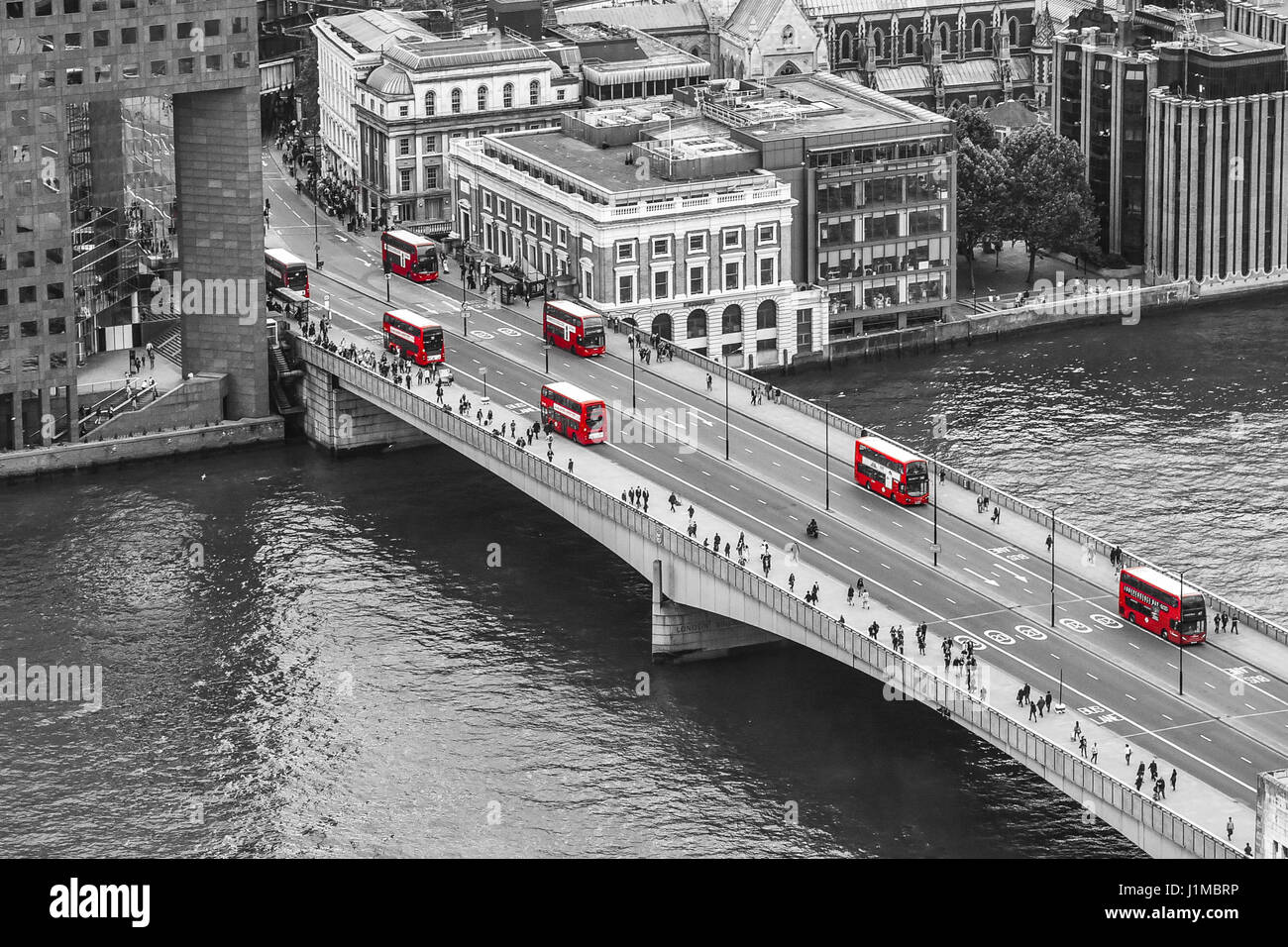 Red double-deckers on London Bridge, London, UK Stock Photo