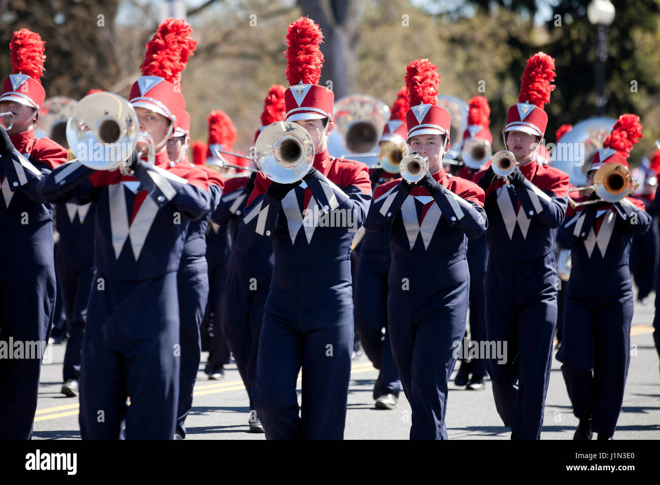 High school marching band trumpet players during street parade - USA Stock Photo