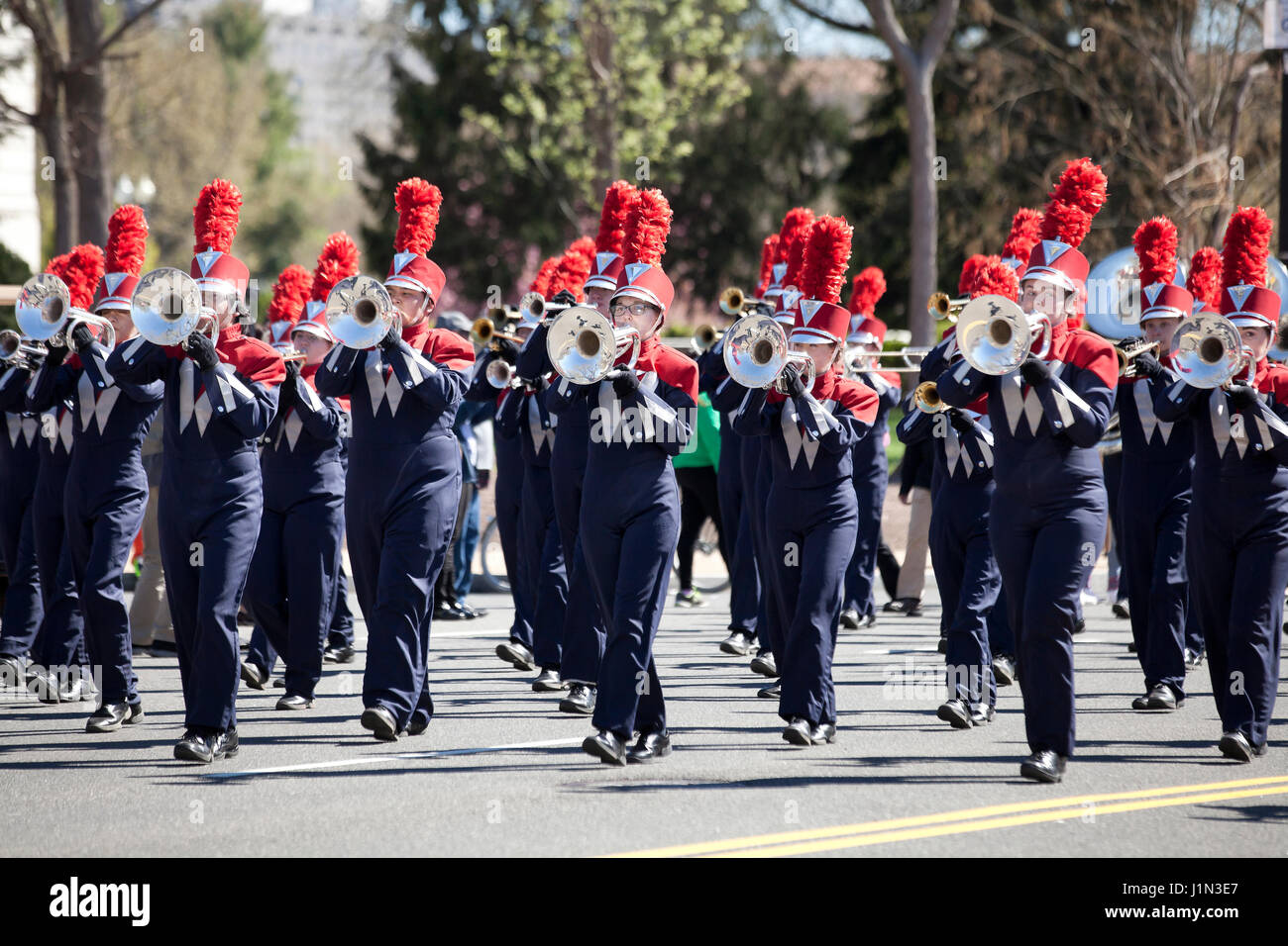 High school marching band trumpet players during street parade - USA Stock Photo