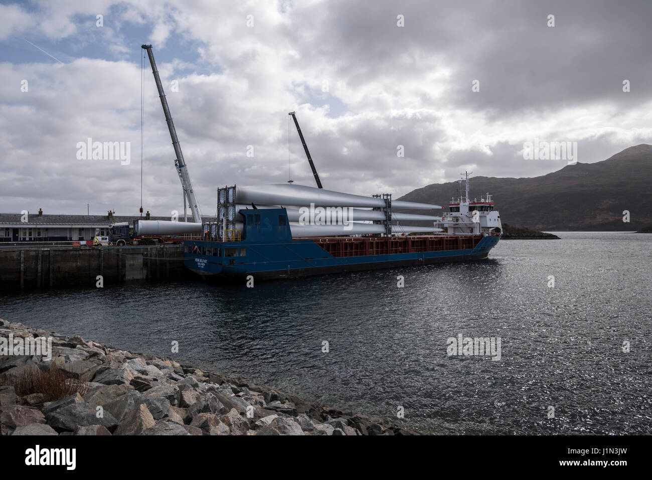 Large wind turbine rotor blades being unloaded from a ship in Kyle of