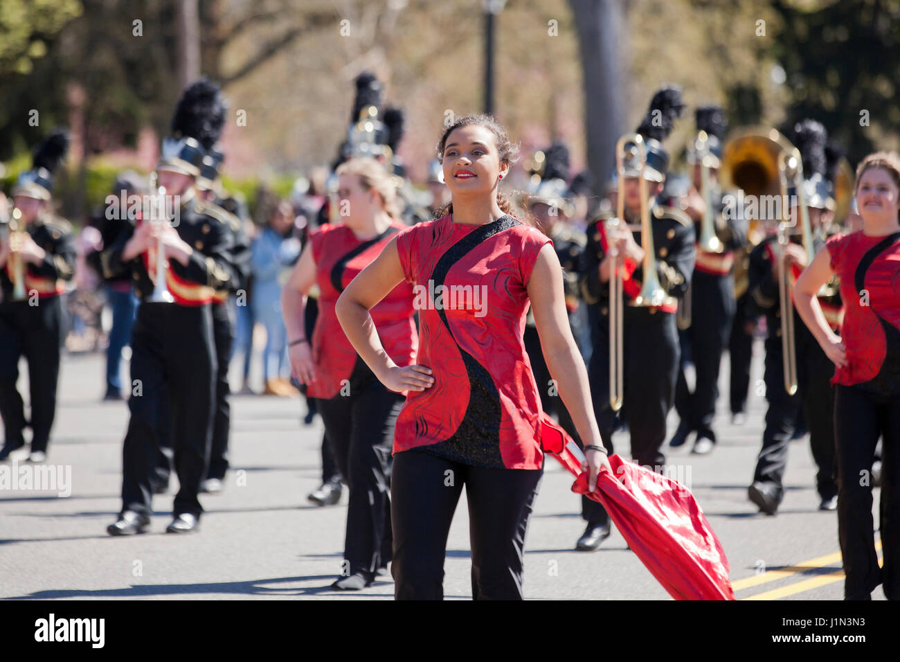 High school cheerleader marching in street parade - USA Stock Photo