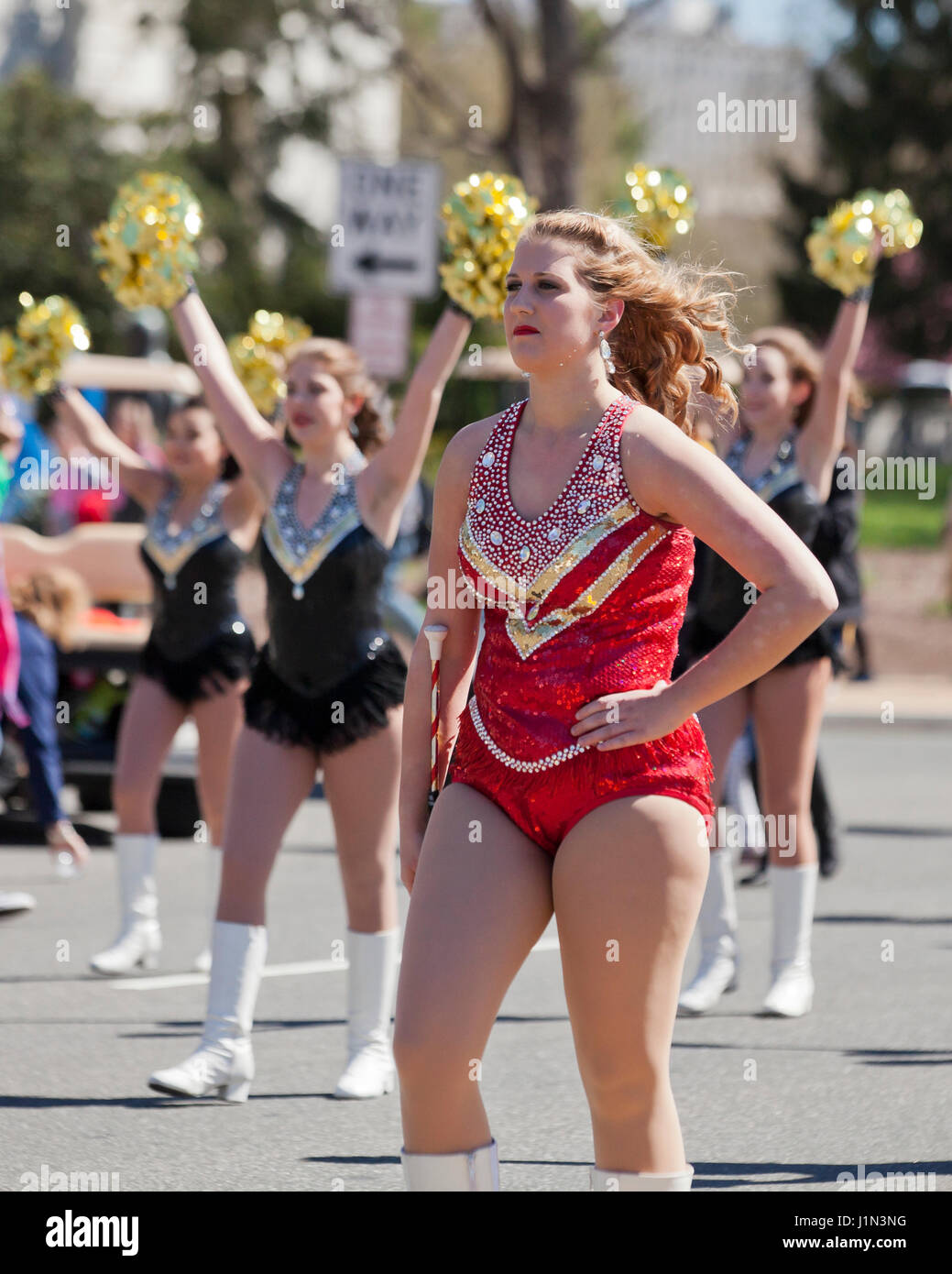 High school cheerleader marching in street parade - USA Stock Photo