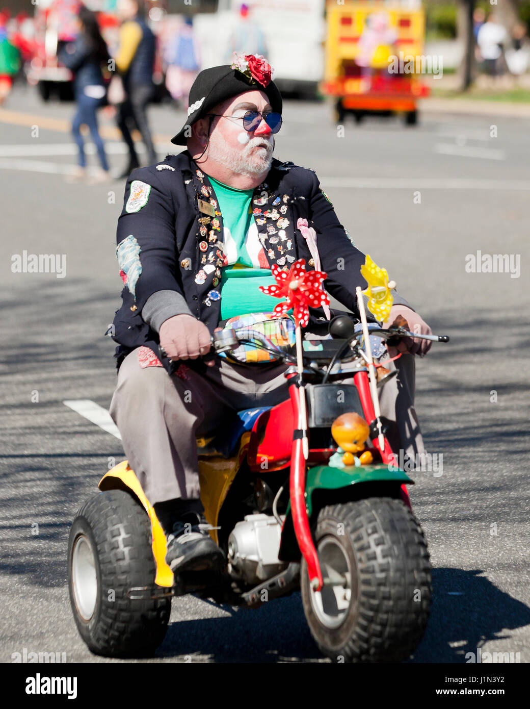 Clown riding  bike during street parade - USA Stock Photo