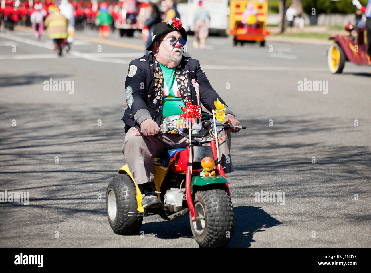 Clown riding  bike during street parade - USA Stock Photo