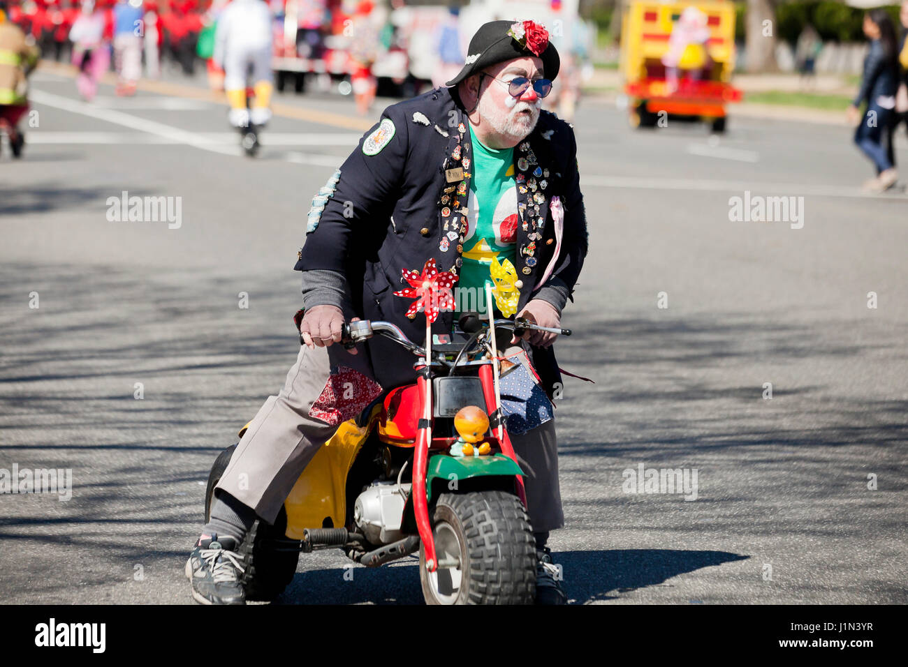 Clown riding  bike during street parade - USA Stock Photo