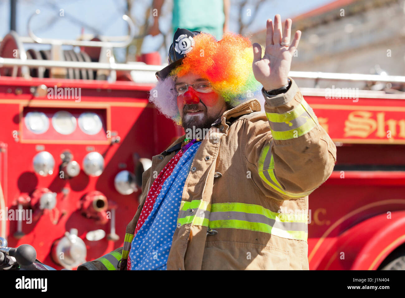 Clowns on firetruck during a street parade - USA Stock Photo
