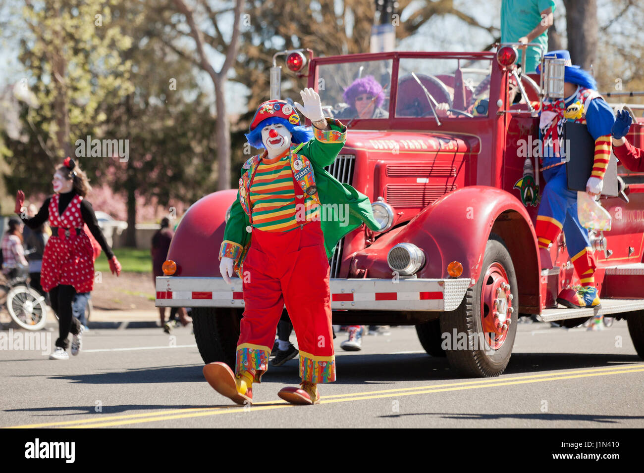 Clowns on firetruck during a street parade - USA Stock Photo