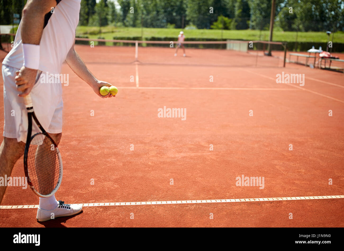 Preparing to serve tennis ball in tennis court Stock Photo Alamy