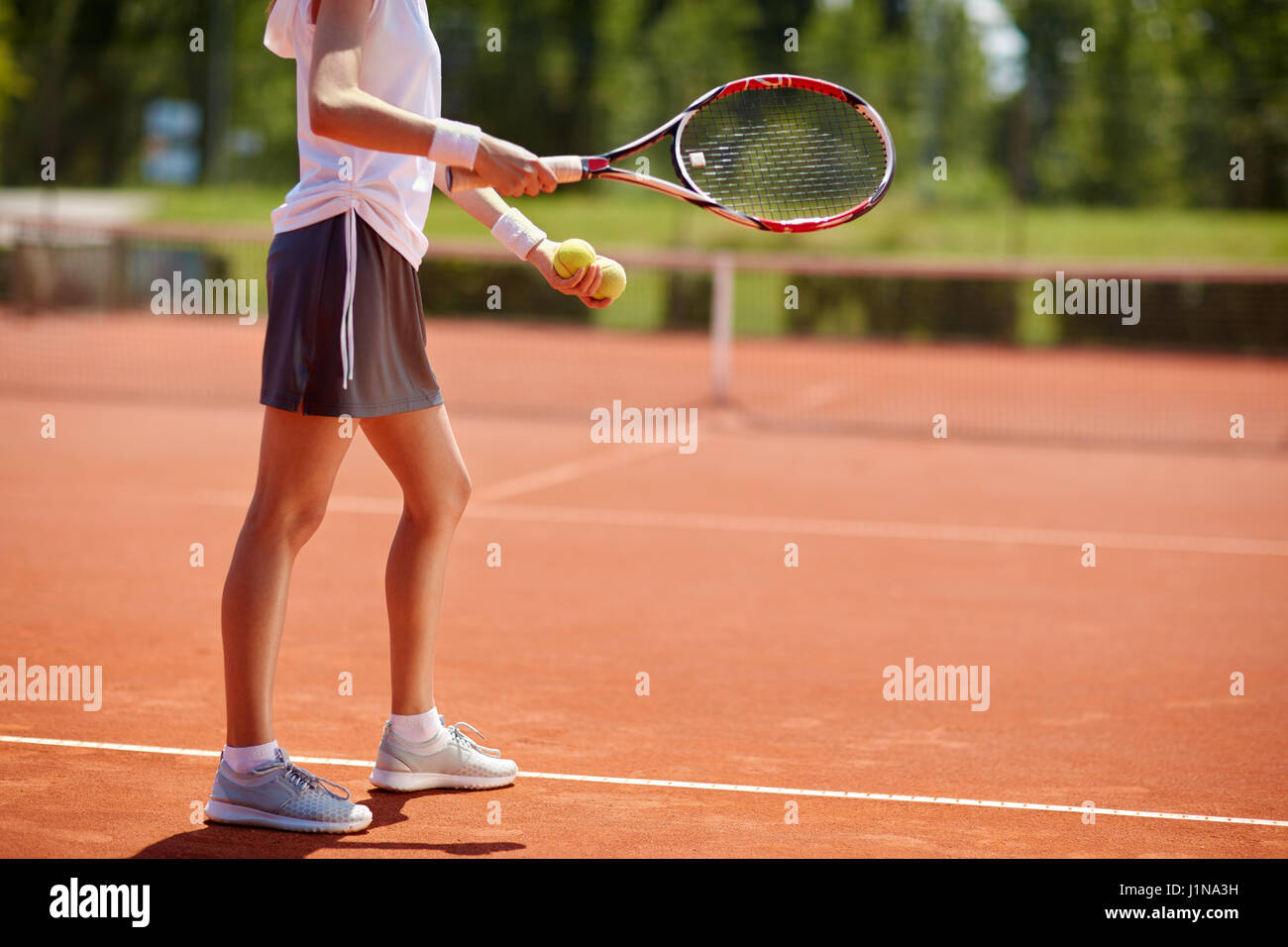 Female tennis player serving tennis balls - body part Stock Photo