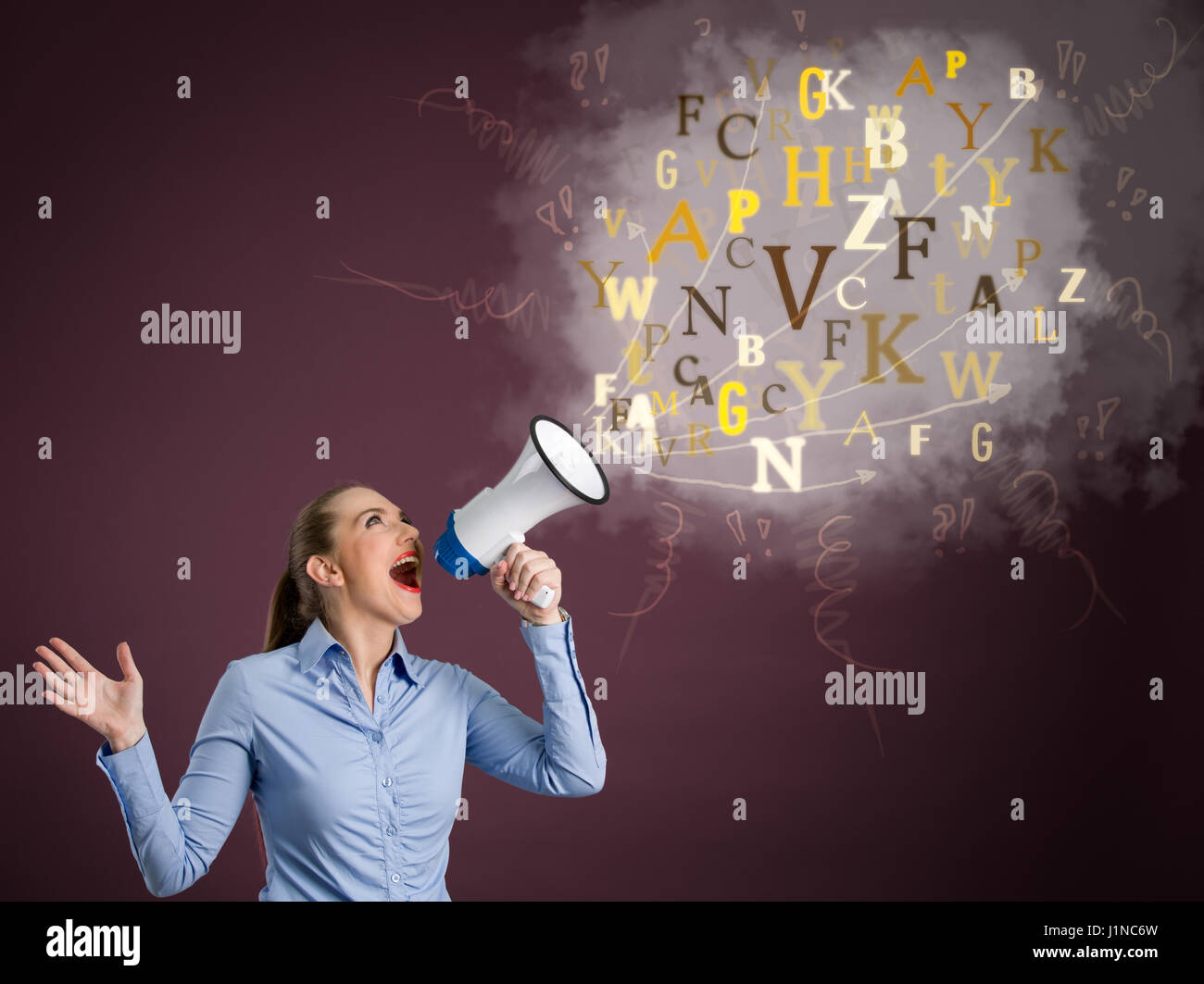 Young business woman screaming into a megaphone Stock Photo
