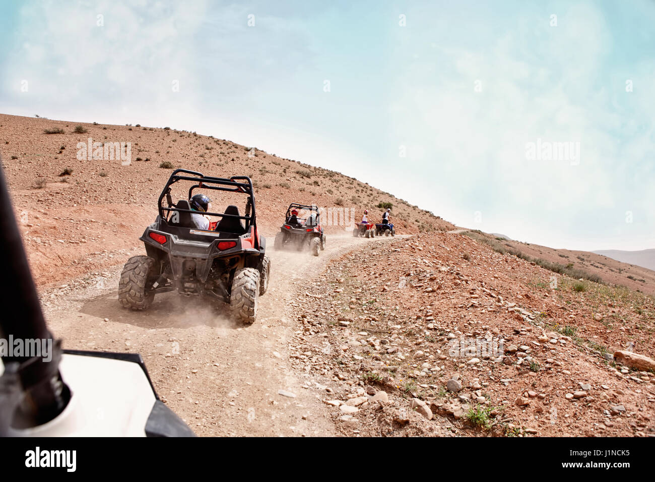 Driving quadbike through the desert in Morocco Stock Photo