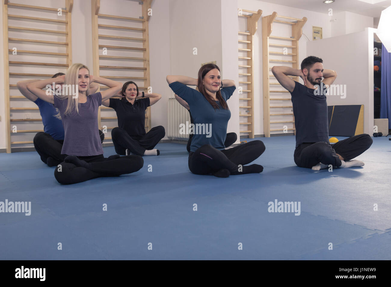 group, six people, warm up, stretch, lying laying floor Stock Photo
