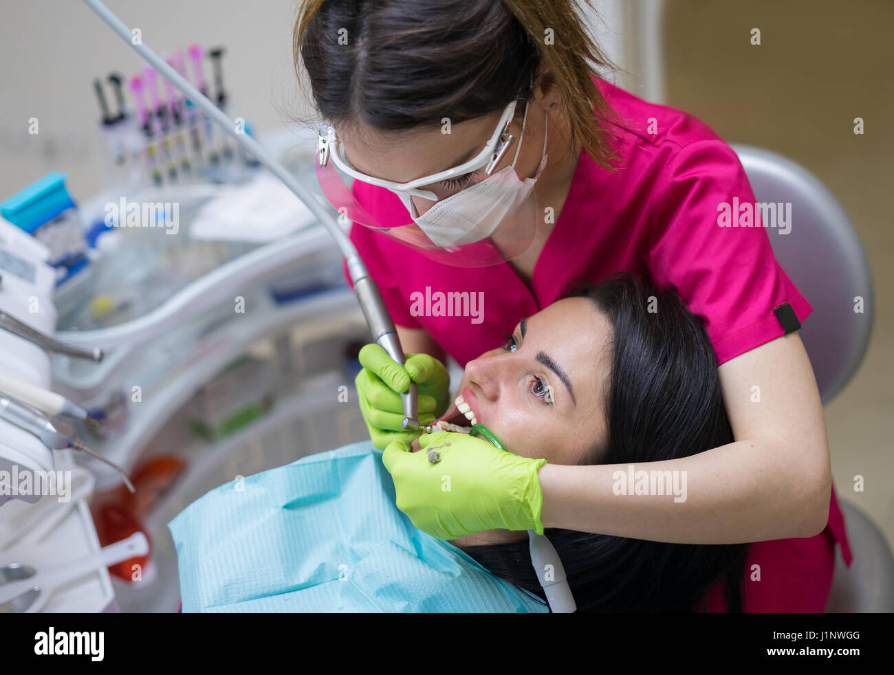 dentist cleaning teeth of woman Stock Photo Alamy