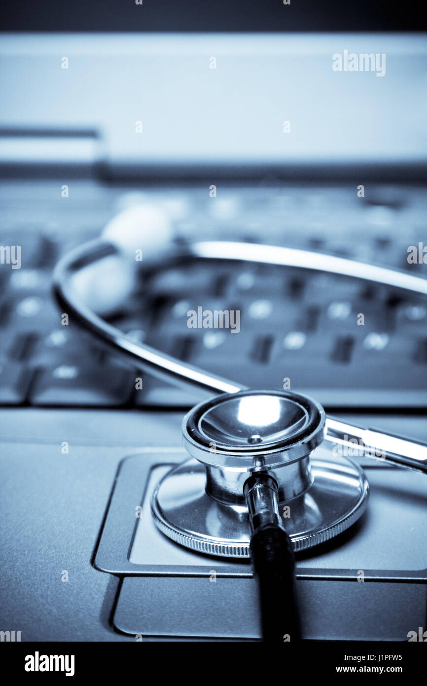 A shot of a stethoscope and a laptop in a blue tone Stock Photo - Alamy