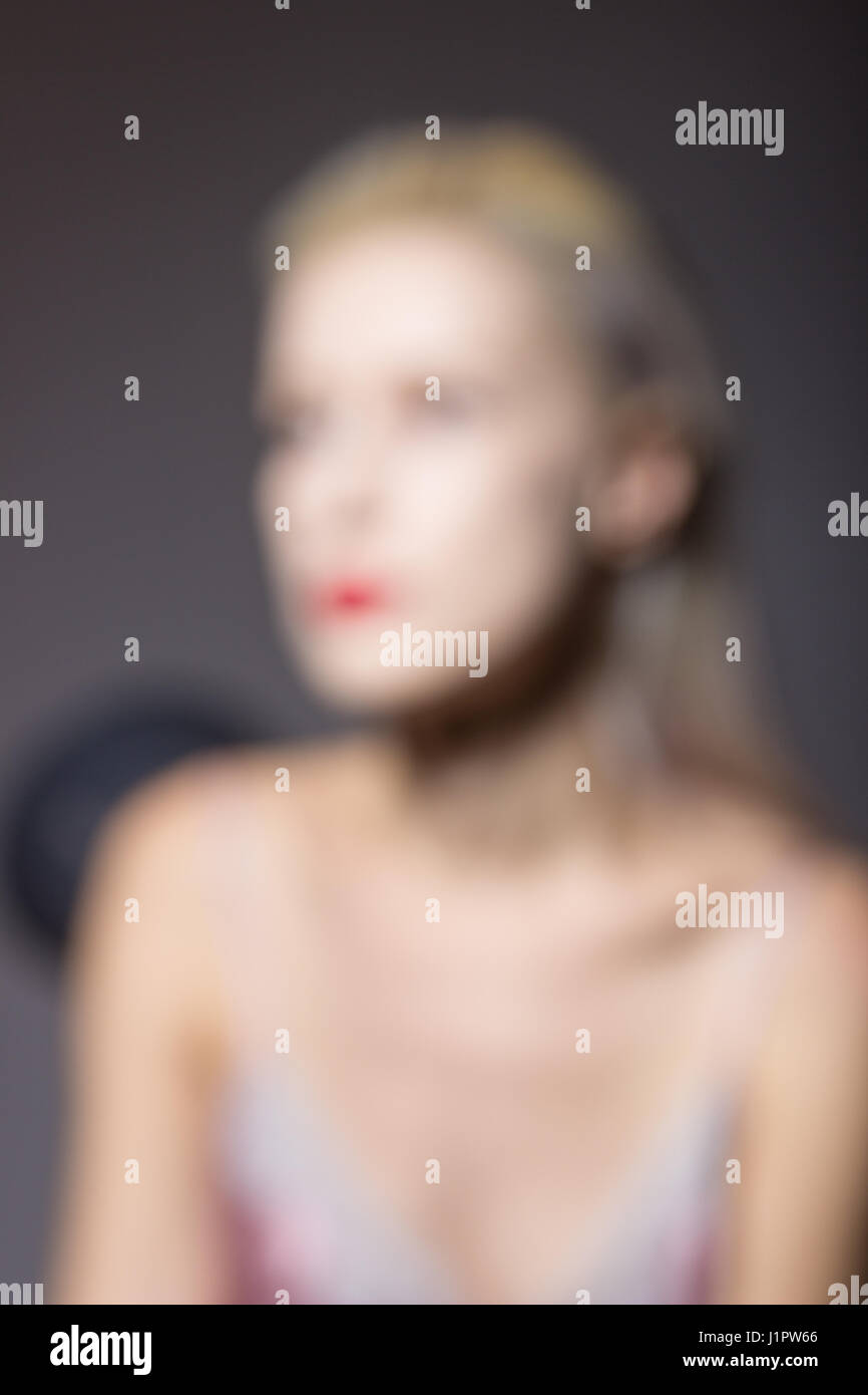 Out of focus, defocused lens, blur. Young woman portrait, head, face, close up, studio. Stock Photo