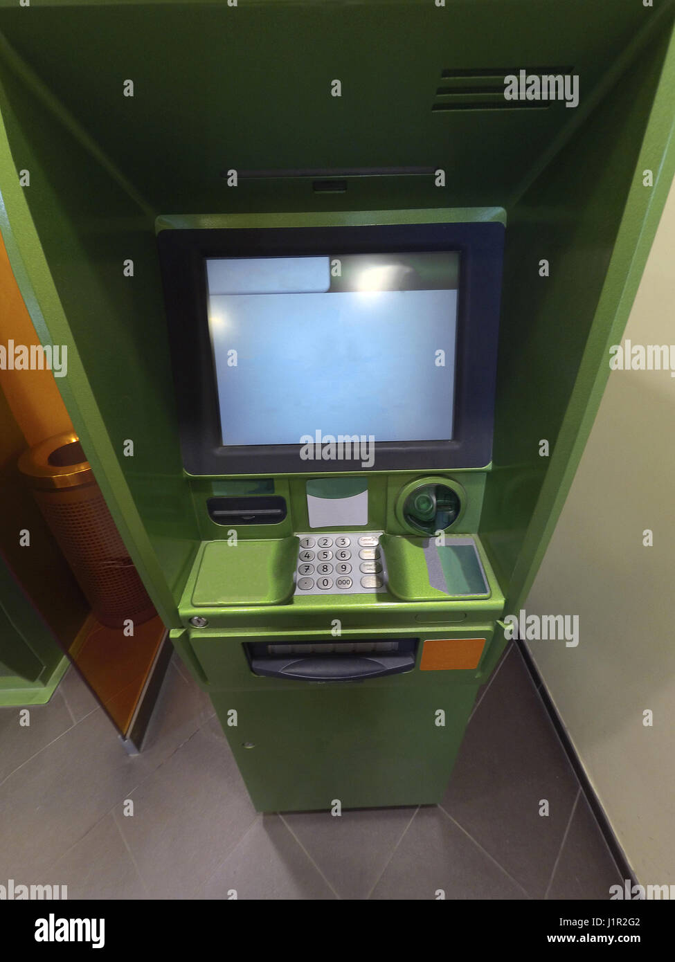 Cash dispenser for green money appearance from the top Stock Photo