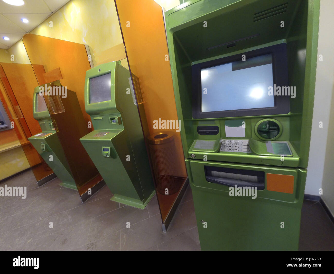 Three cash dispensers for issuing money green ready for work Stock Photo