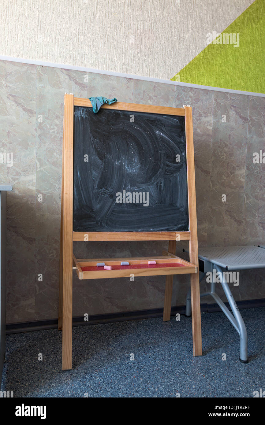 blackboard chalk drawing stands near the wall Stock Photo