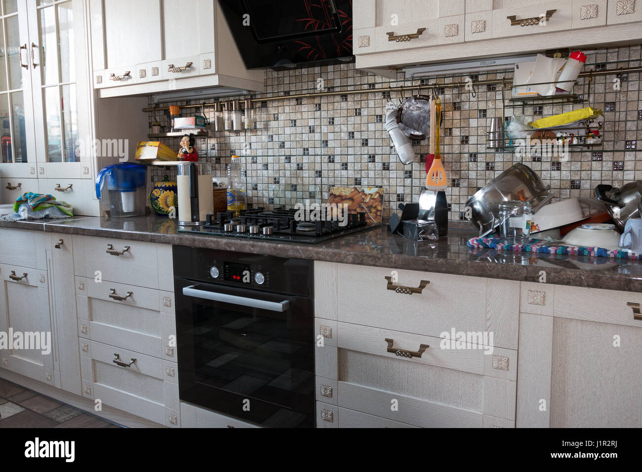 kitchen furniture, kitchen utensils and gas appliances in the apartment Stock Photo