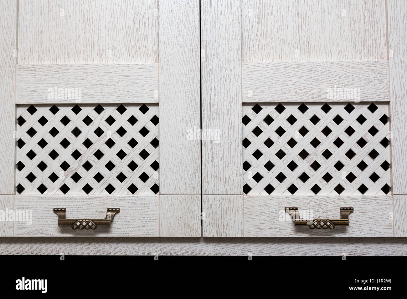 cabinet doors with wooden bars and metal handles in style Stock Photo