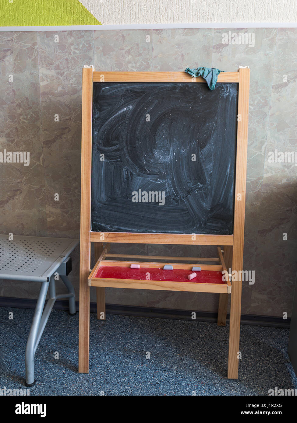 chalk drawing board is near the wall Stock Photo