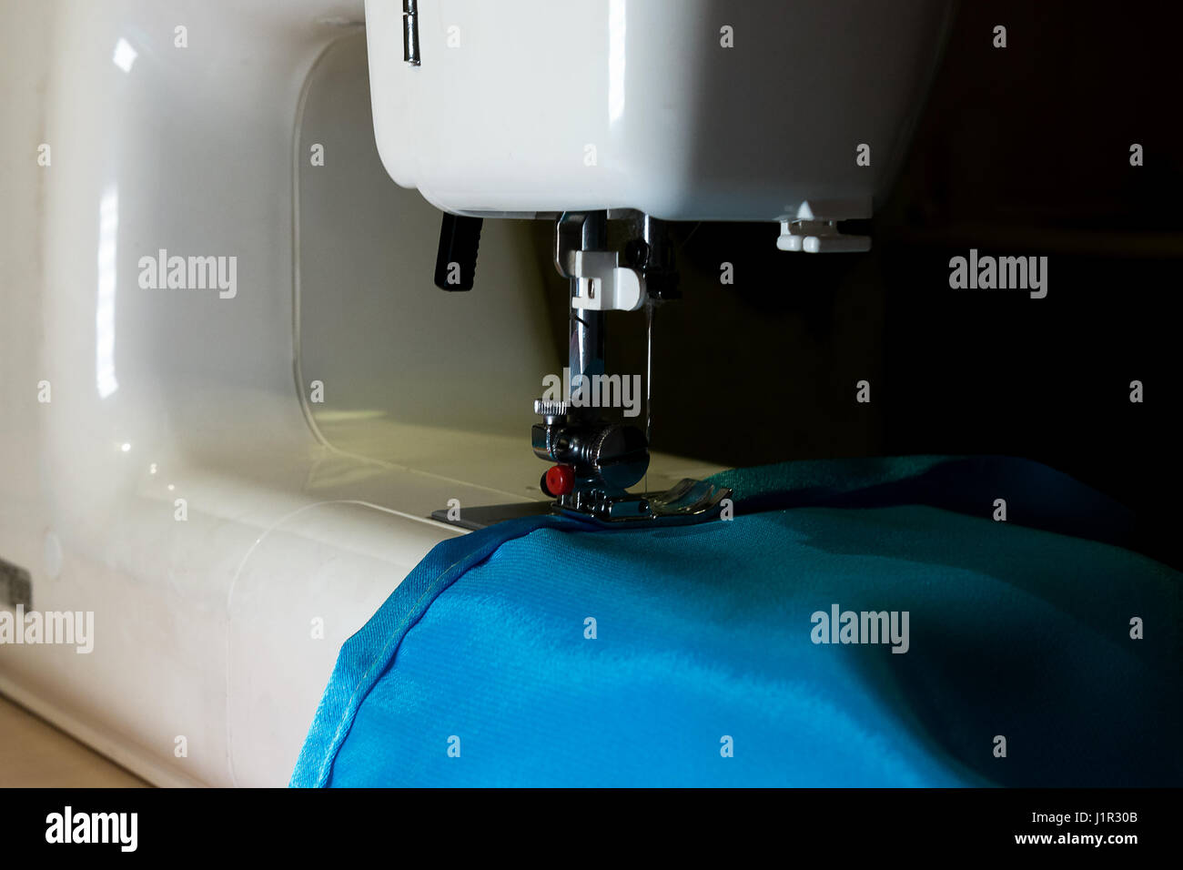 white sewing machine to sew a fabric Stock Photo