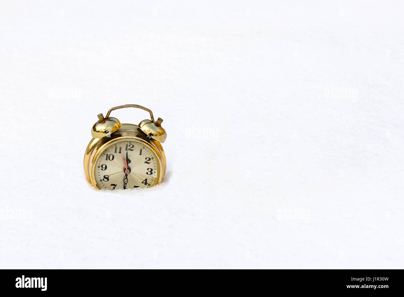 gold watch on a pure white snow Stock Photo