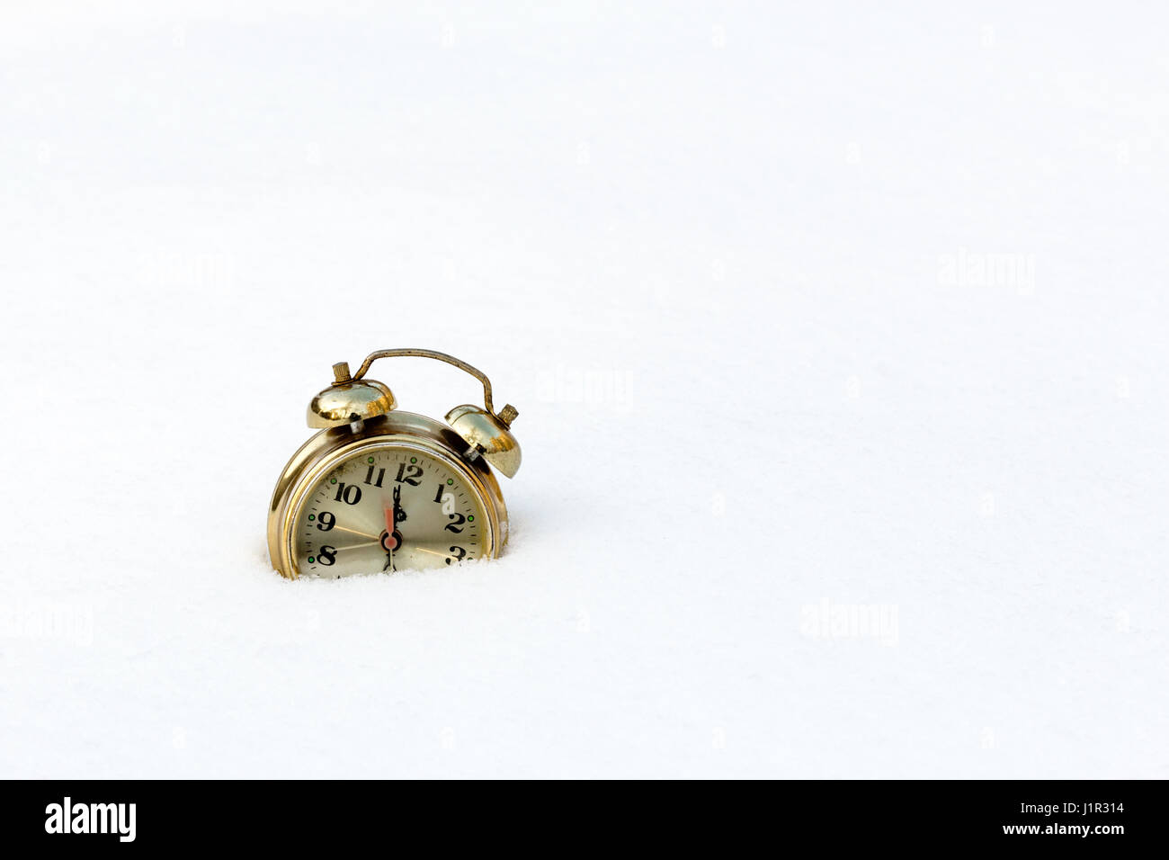 old clock in the pure white snow Stock Photo