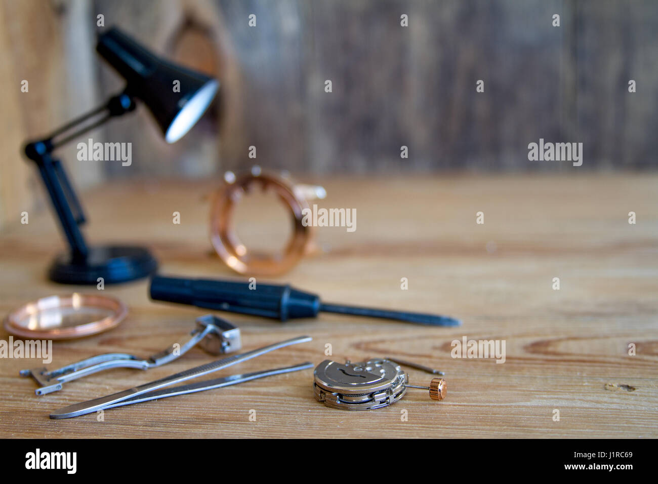 Special tools for repairing the clock on a wooden background. Stock Photo