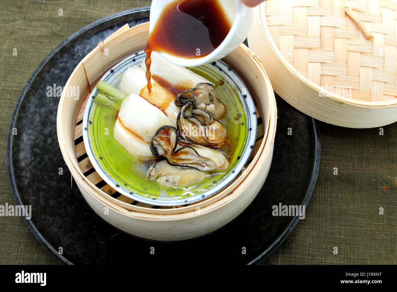 Oyster soup with produce and radish in bamboo tray Stock Photo Alamy