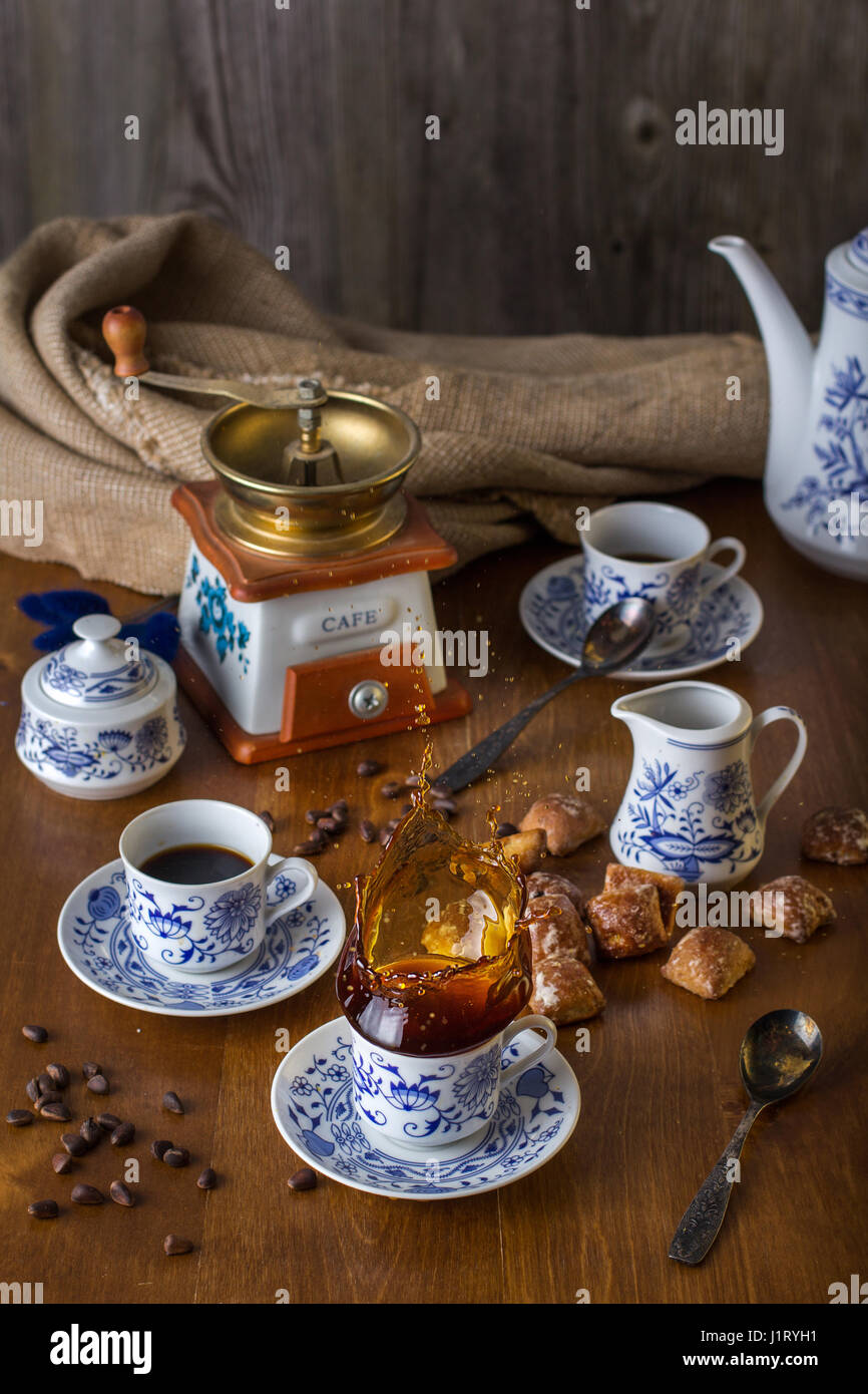 An ancient coffee set with hot coffee in a rustic style, splash Stock ...