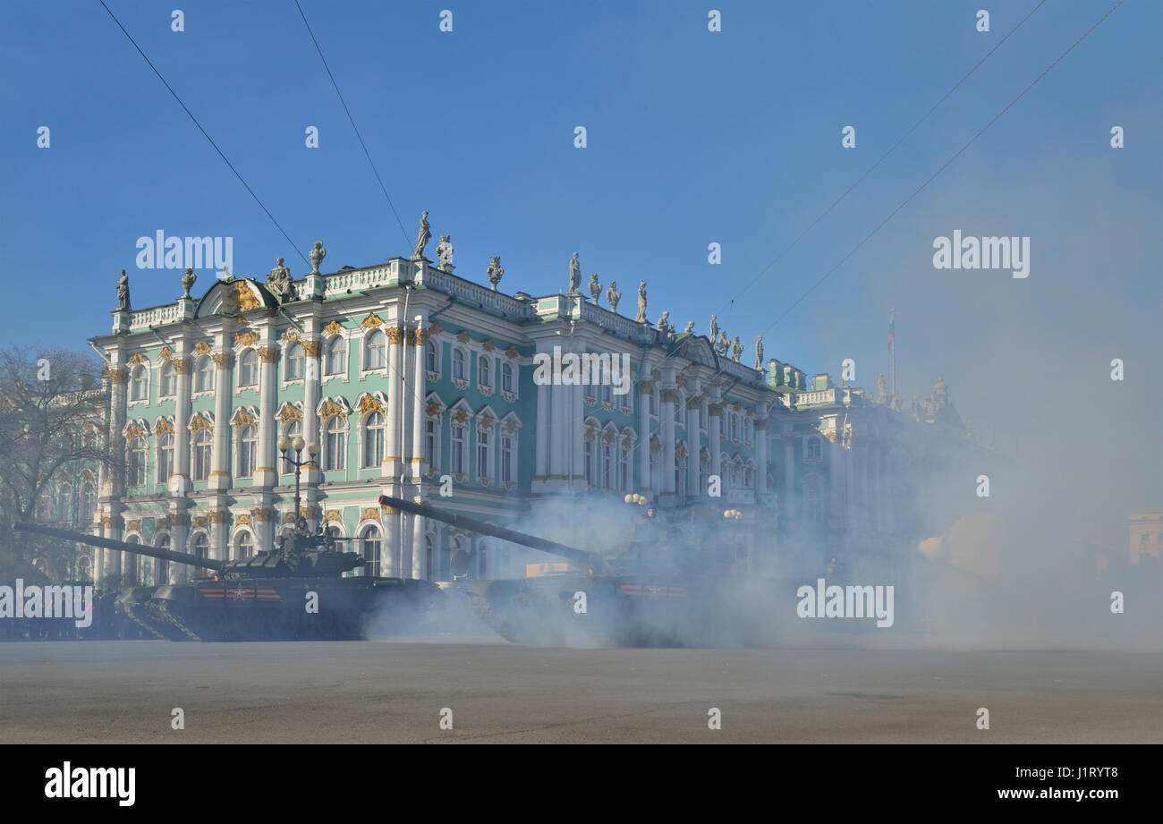 ST.PETERSBURG, RUSSIA - MAY 05, 2016:  Tanks T-90 with a red flag in a puff of smoke at the Palace square during a rehearsal of the Victory Parade  in Stock Photo