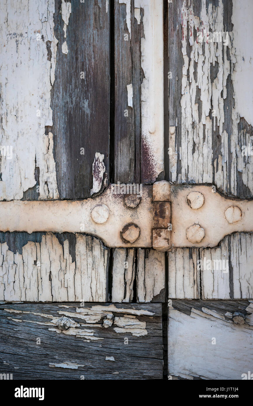 Detail of old wooden window shutters with rusty iron hinge and peeling ...
