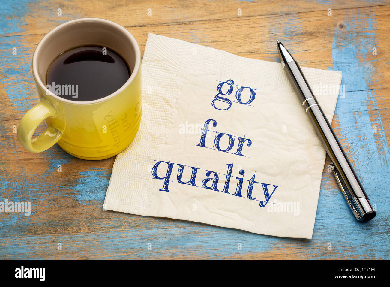 Go for quality advice or reminder - handwriting on a napkin with a cup of espresso coffee Stock Photo