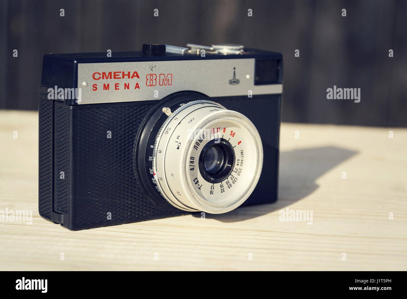 BOROTIN, CZECH REPUBLIC - MARCH 25: Smena 8M old vintage filtered camera on wooden background on March 25, 2017 in Borotin, Czech republic. Stock Photo