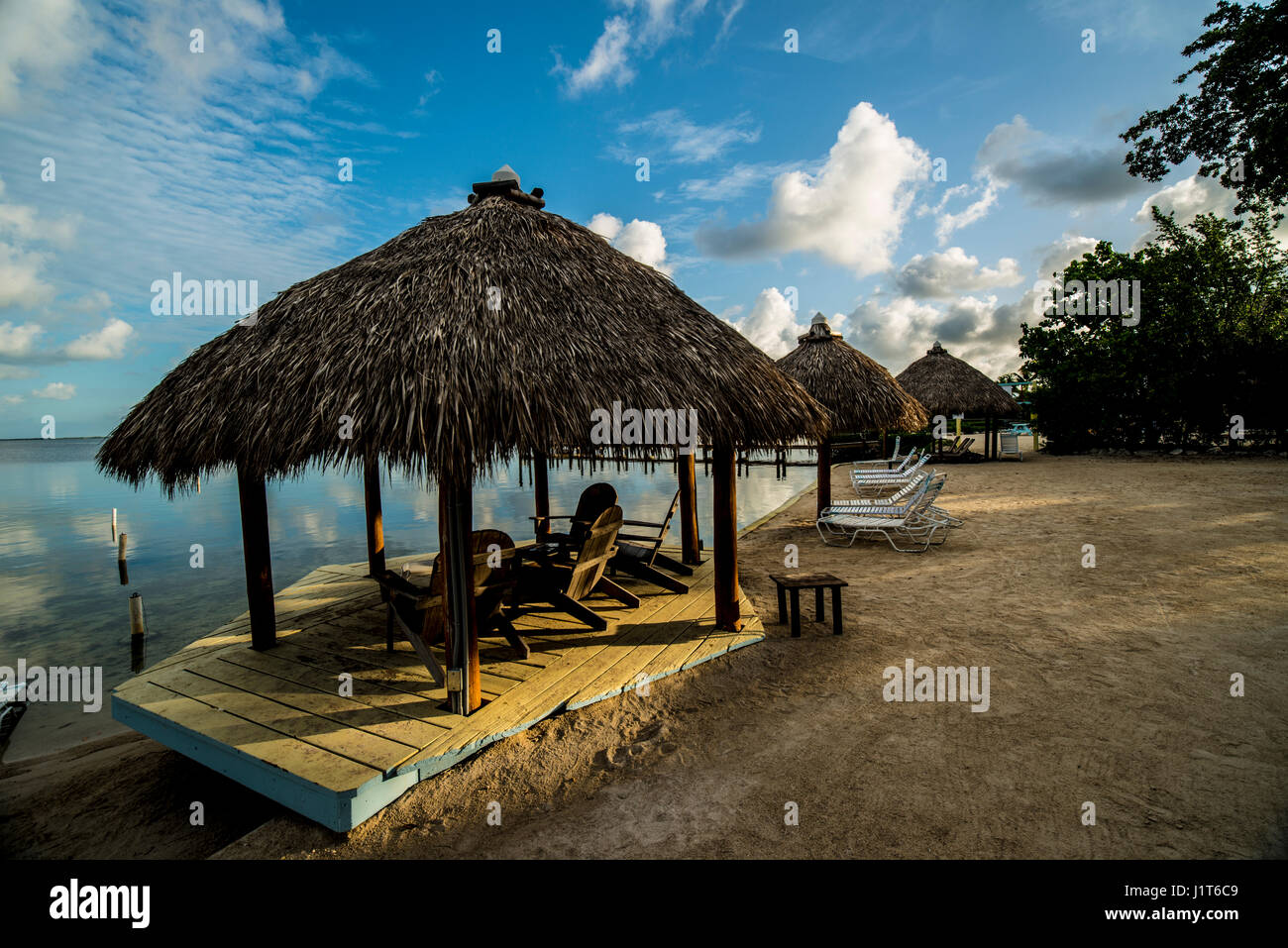 tropical tiki huts by the ocean Stock Photo - Alamy
