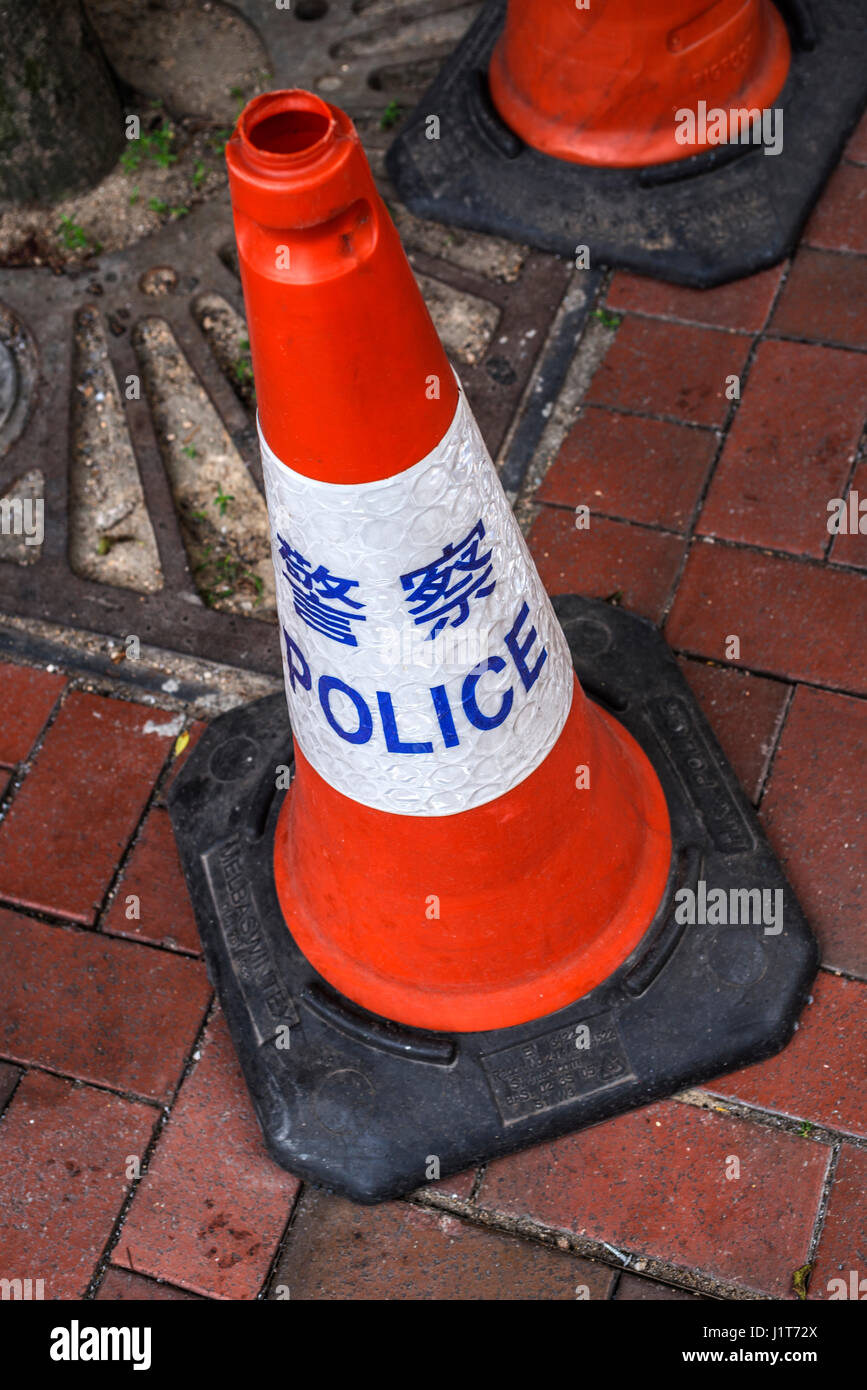 Police Warning Cones in Chinese and English Stock Photo