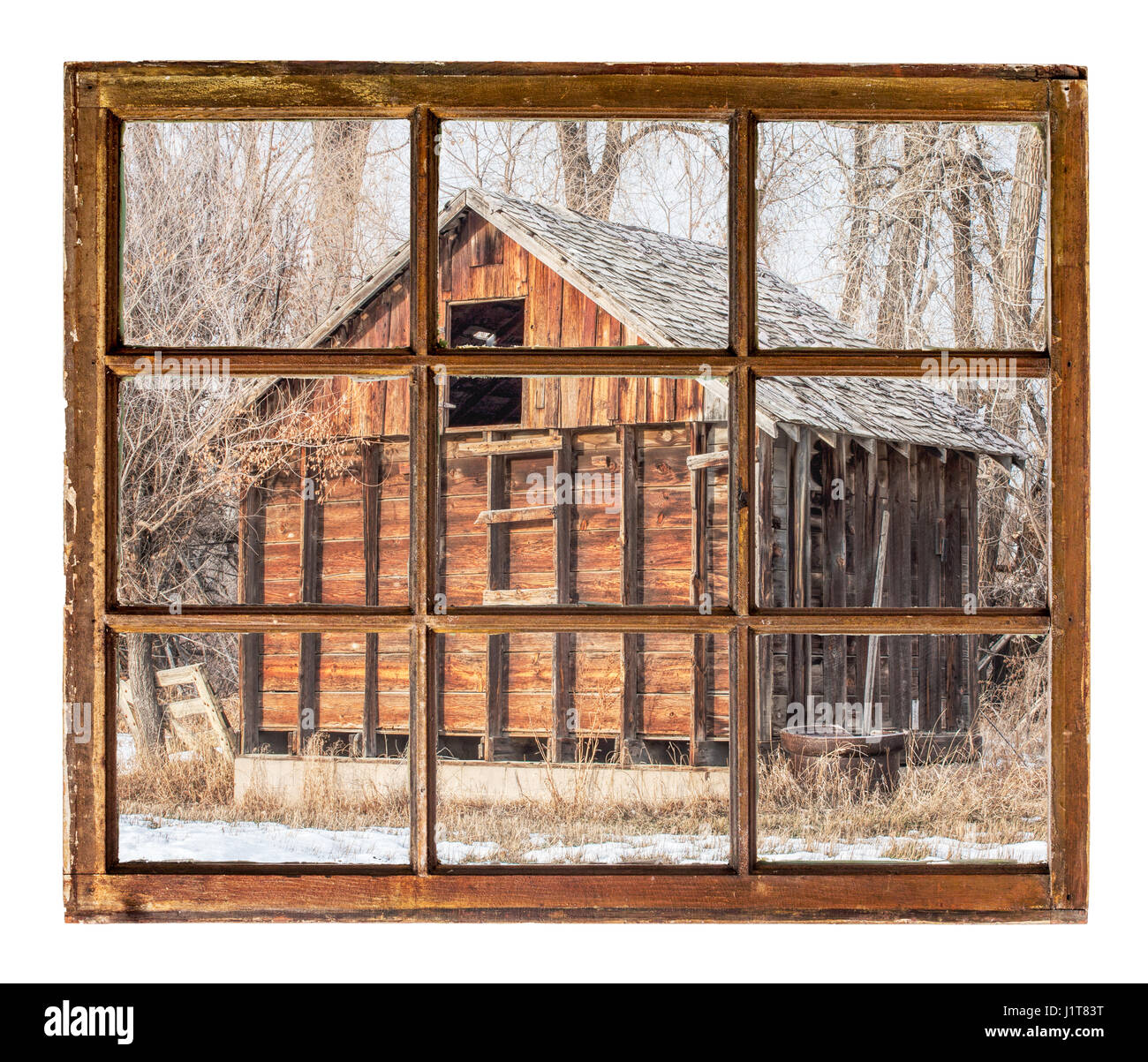 Old rustic barn in cottonswoods as seen  through vintage, grunge, sash window with dirty glass Stock Photo