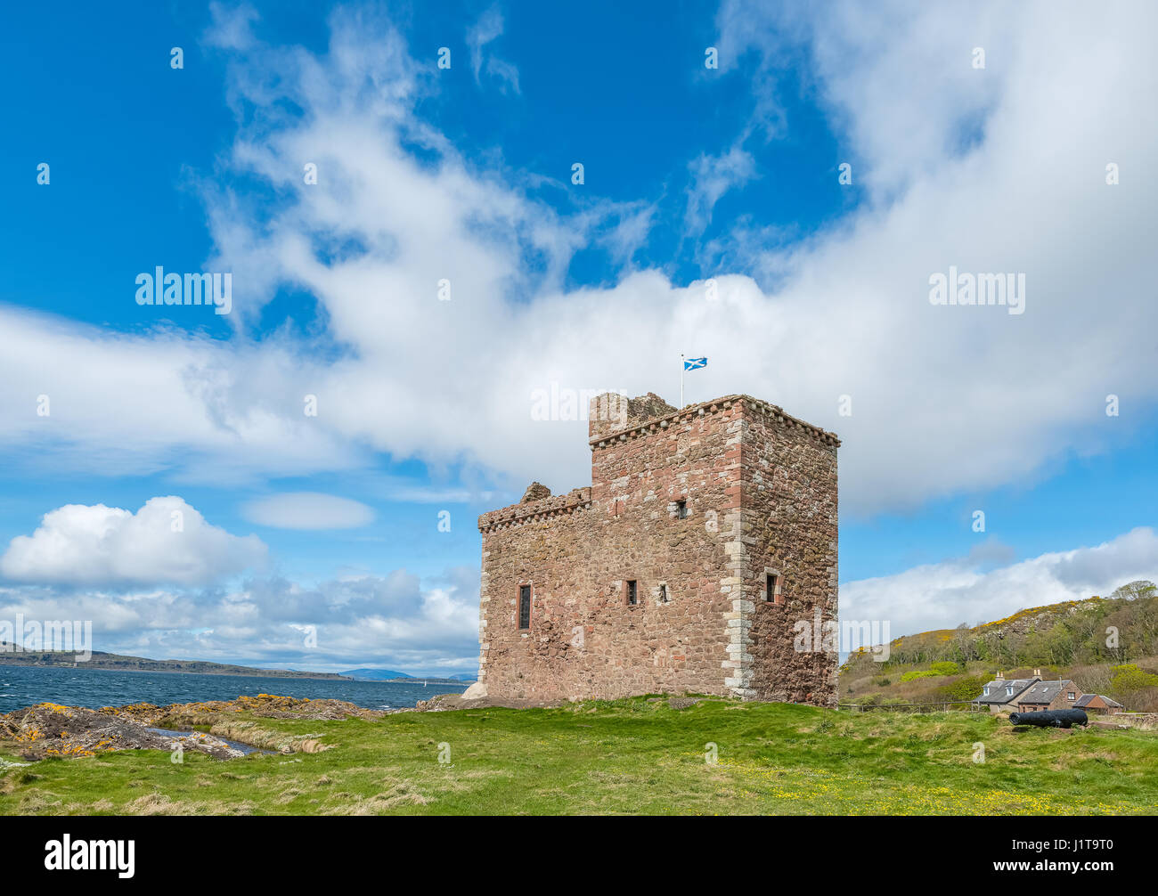 Portencross Castle on a clear day with blue sky's and the Cmbrae's and Arran in the back ground. Stock Photo