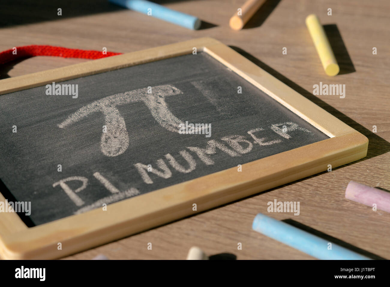 Pi number. Blackboard. Colorful chalks. Stock Photo