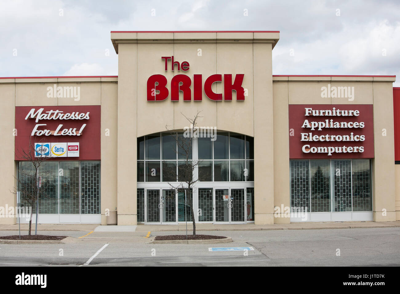 A logo sign outside of a The Brick retail store in Mississauga, Ontario