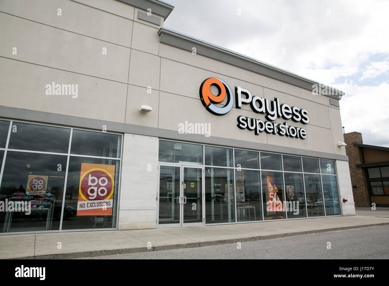 A logo sign outside of a Payless ShoeSource retail store in Mississauga, Ontario, Canada, on April 16, 2017. Stock Photo