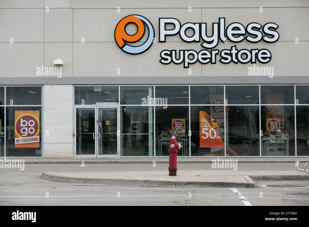 A logo sign outside of a Payless ShoeSource retail store in Mississauga, Ontario, Canada, on April 16, 2017. Stock Photo